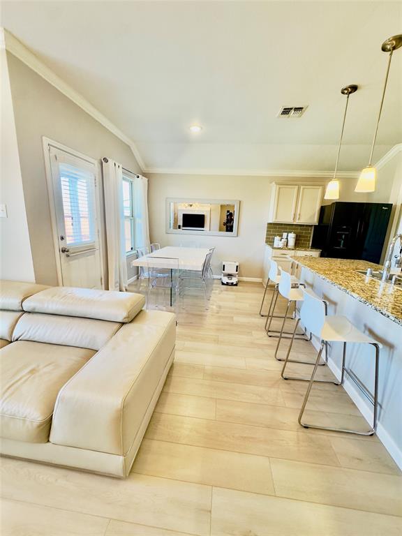 1508 Wild Rye Circle Princeton, TX 75407 - Photo 8 of 17 Living area with crown molding and baseboards