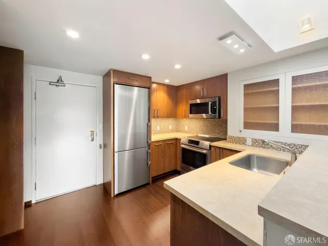 a kitchen with a refrigerator stove and sink