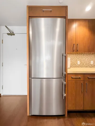 a utility room with wooden floor and cabinet