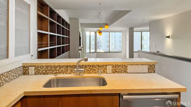a view of a kitchen with wooden floor and a sink