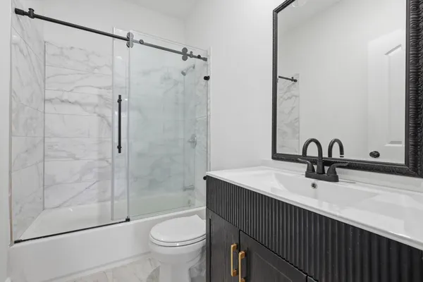 a bathroom with a sink toilet and shower