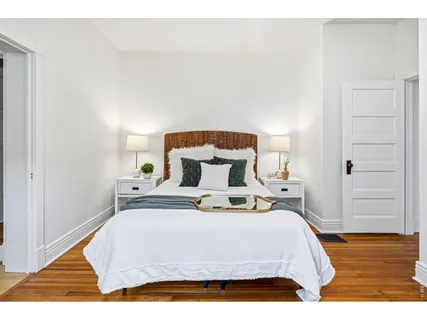 a bedroom with a bed and a potted plant