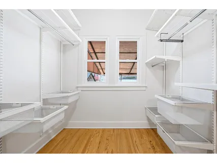 a bedroom with a bed and a potted plant