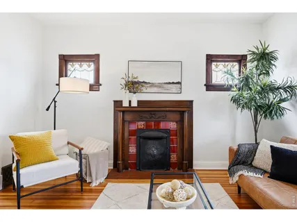 a view of a livingroom with furniture window and wooden floor