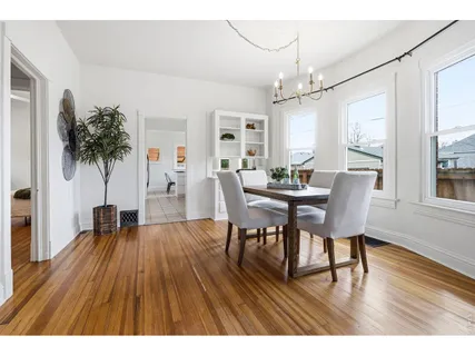 a view of a dining room with furniture wooden floor and chandelier