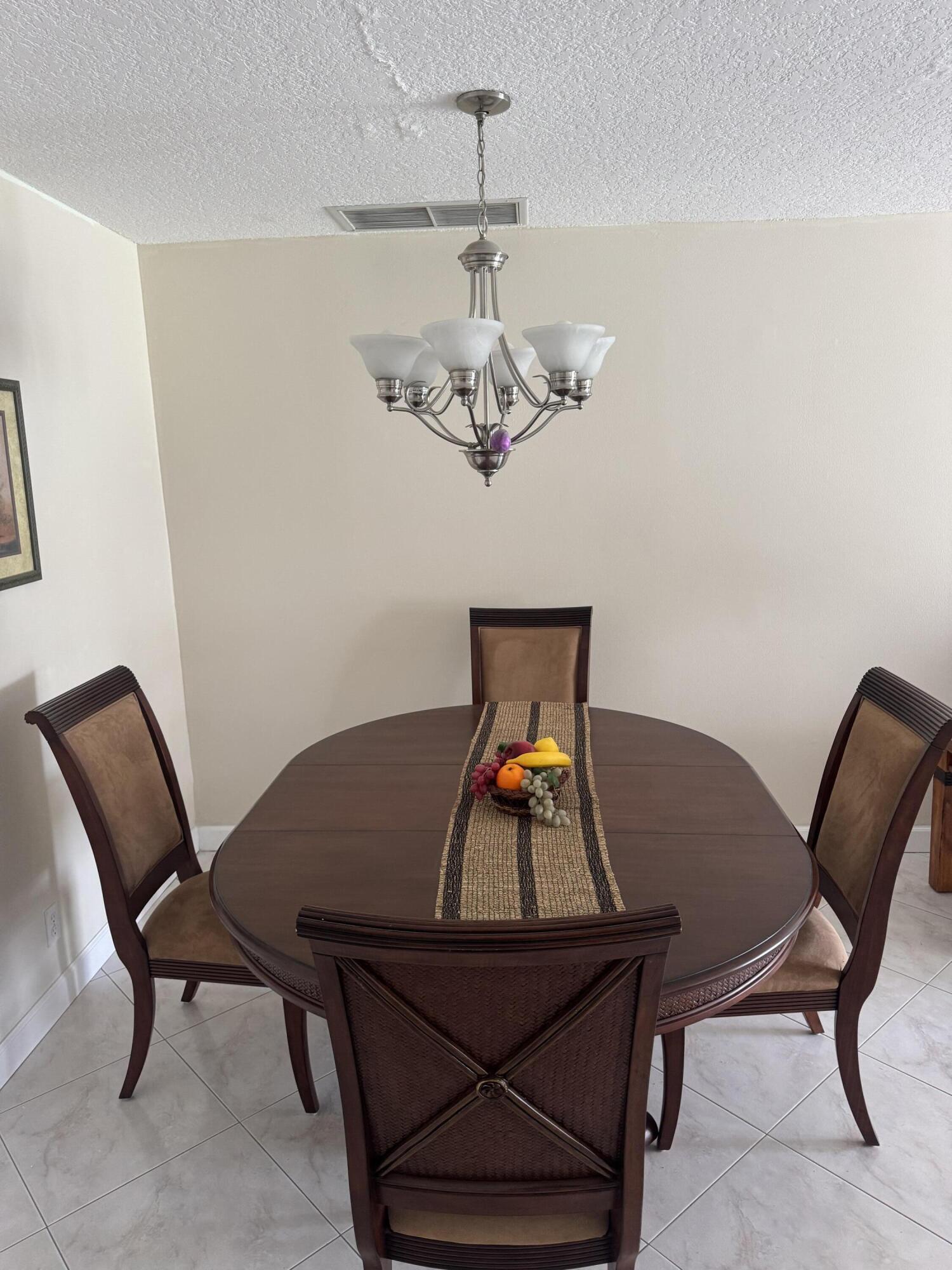 8892 Bella Vista Drive, Unit 333 Boca Raton, FL 33433 - Photo 11 of 18 a view of a dining room with furniture and wooden floor
