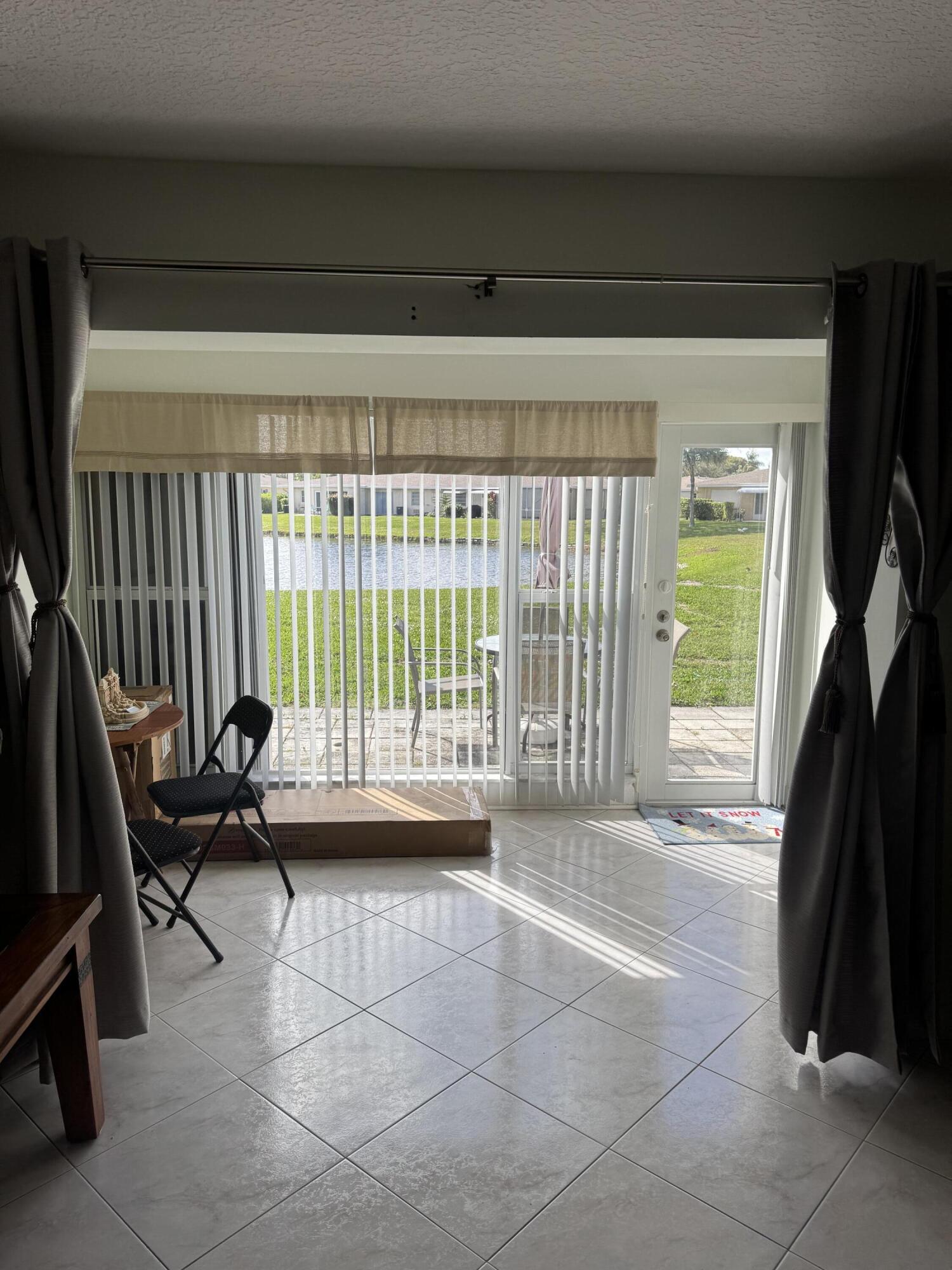 8892 Bella Vista Drive, Unit 333 Boca Raton, FL 33433 - Photo 12 of 18 a living room with a couch and a large window