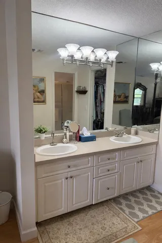 a bathroom with a double vanity sink and a mirror