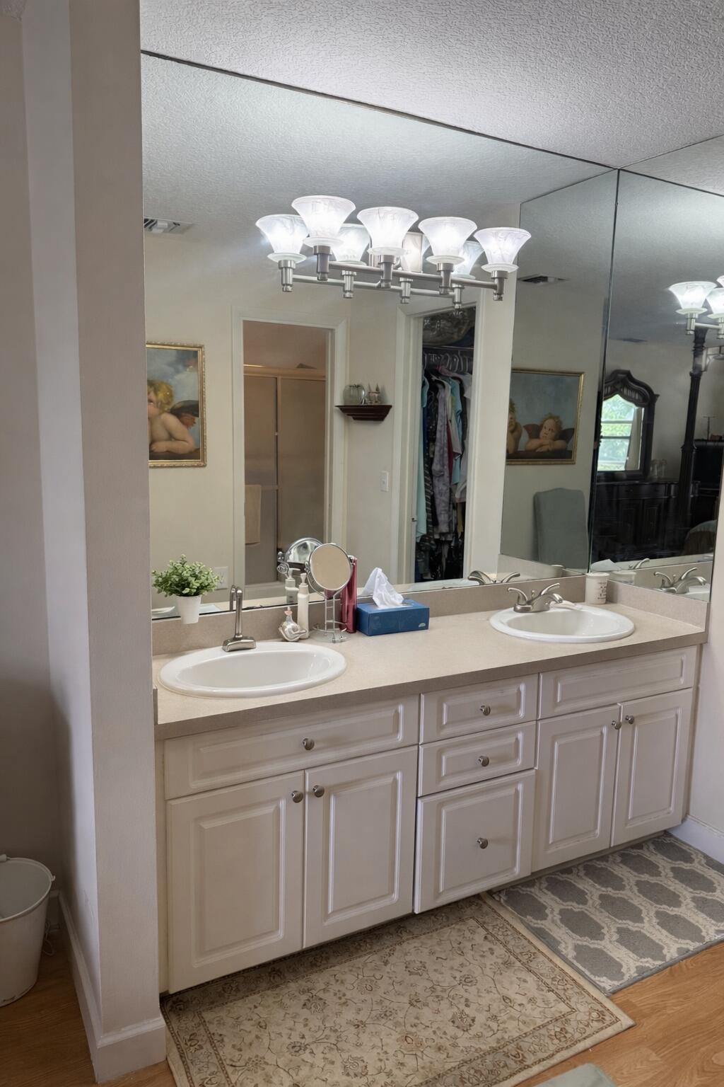 8892 Bella Vista Drive, Unit 333 Boca Raton, FL 33433 - Photo 16 of 18 a bathroom with a double vanity sink and a mirror