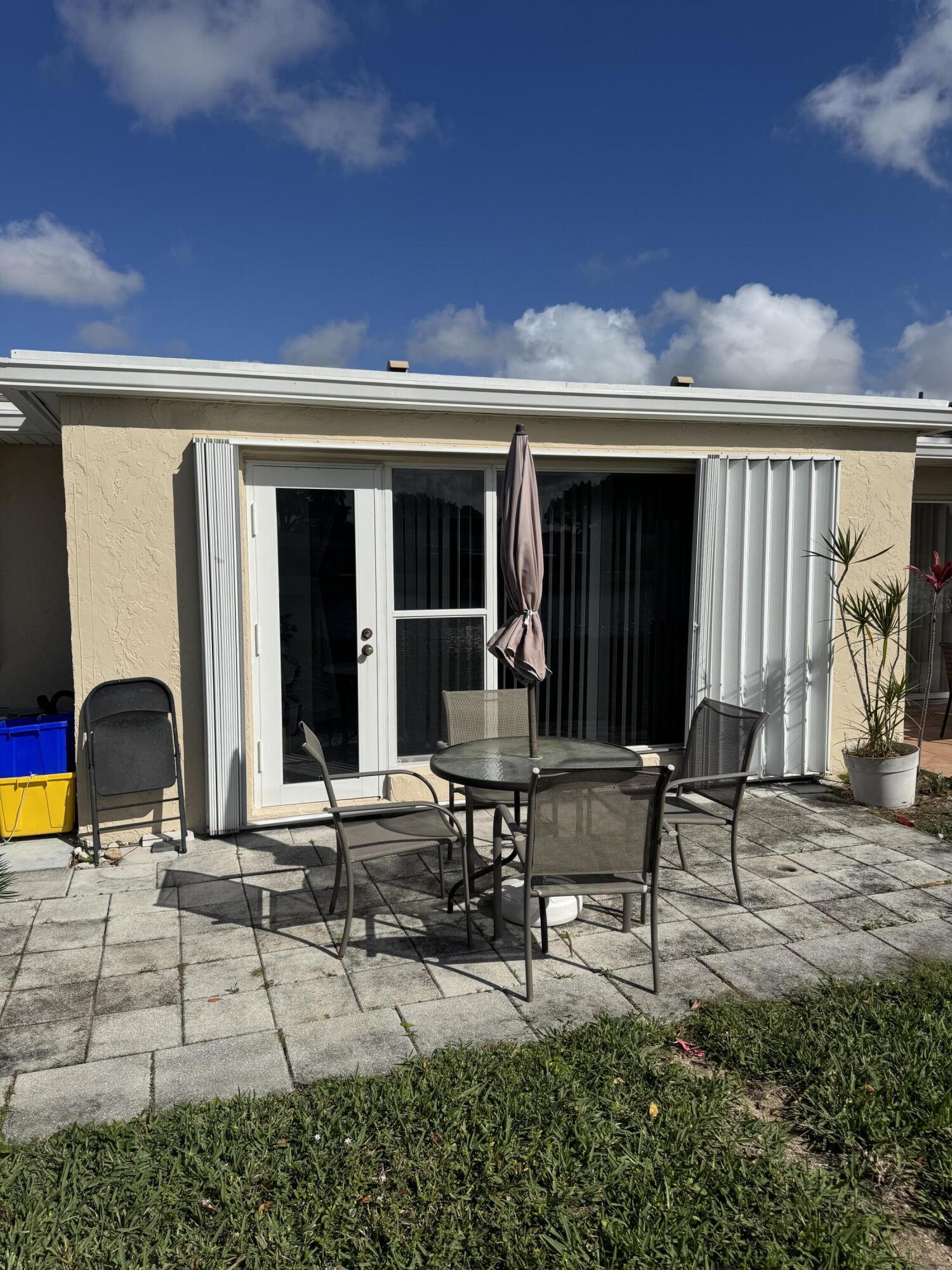 8892 Bella Vista Drive, Unit 333 Boca Raton, FL 33433 - Photo 18 of 18 a building outdoor space with patio furniture and potted plants