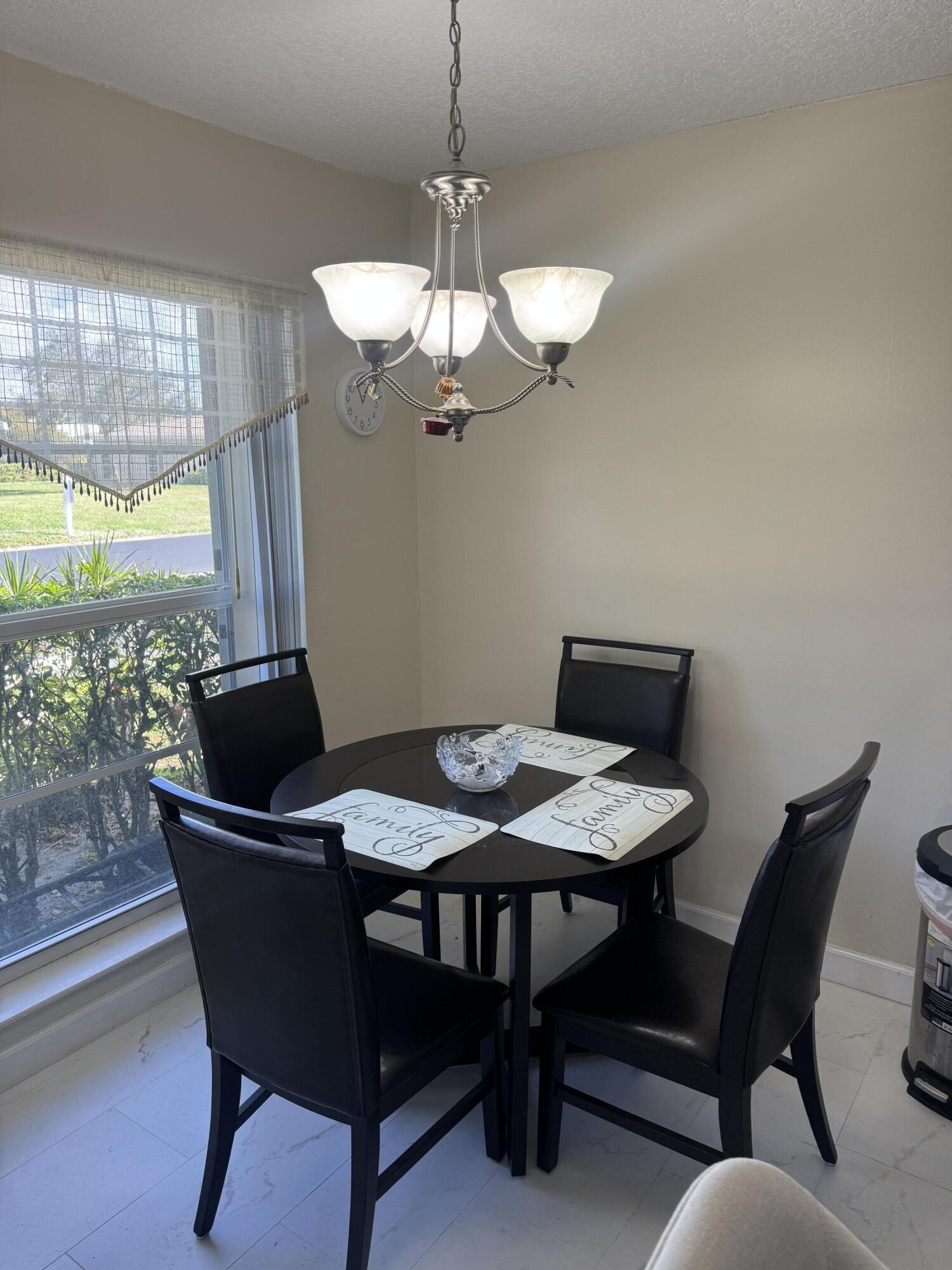 8892 Bella Vista Drive, Unit 333 Boca Raton, FL 33433 - Photo 6 of 18 a dining room with furniture and window