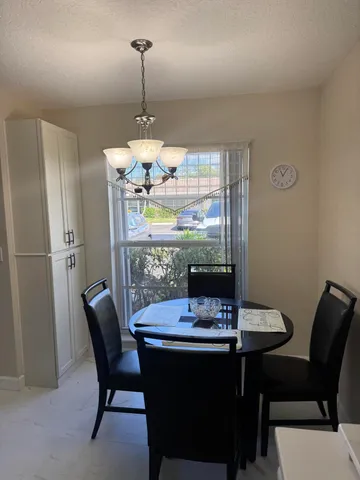 a view of a dining room with furniture window and outside view