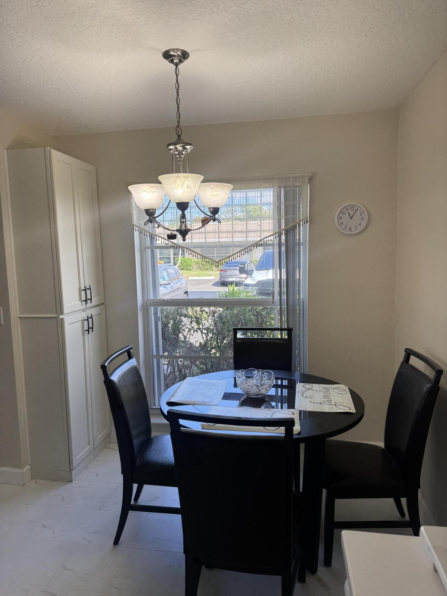 8892 Bella Vista Drive, Unit 333 Boca Raton, FL 33433 - Photo 7 of 18 a view of a dining room with furniture window and outside view