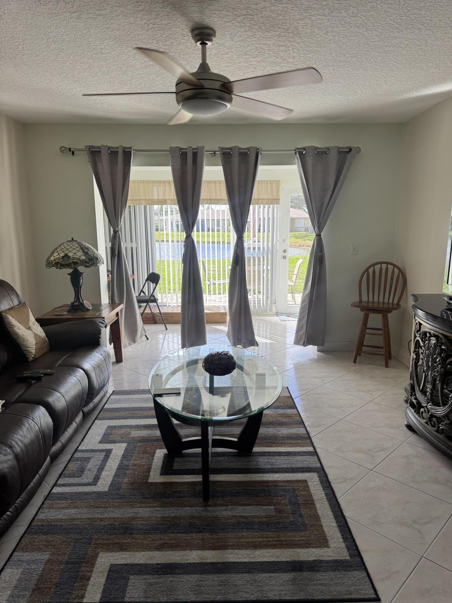 8892 Bella Vista Drive, Unit 333 Boca Raton, FL 33433 - Photo 10 of 18 a living room with furniture and a window