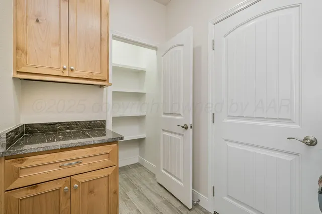 a kitchen with white cabinets and a stove