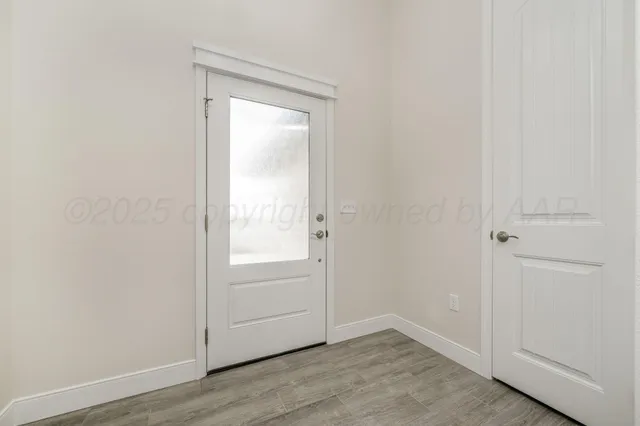 an empty room with wooden floor and closet