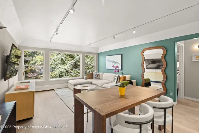 a view of a dining room with furniture and a large window