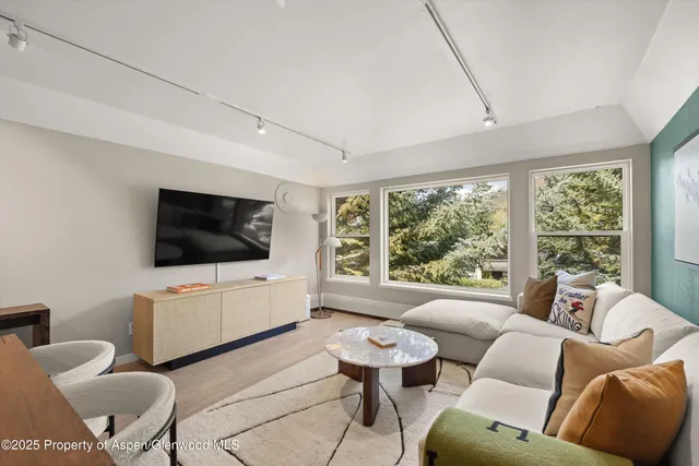 a living room with furniture and a flat screen tv