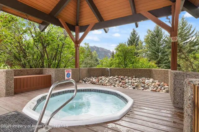 a roof deck with table and chairs and wooden floor