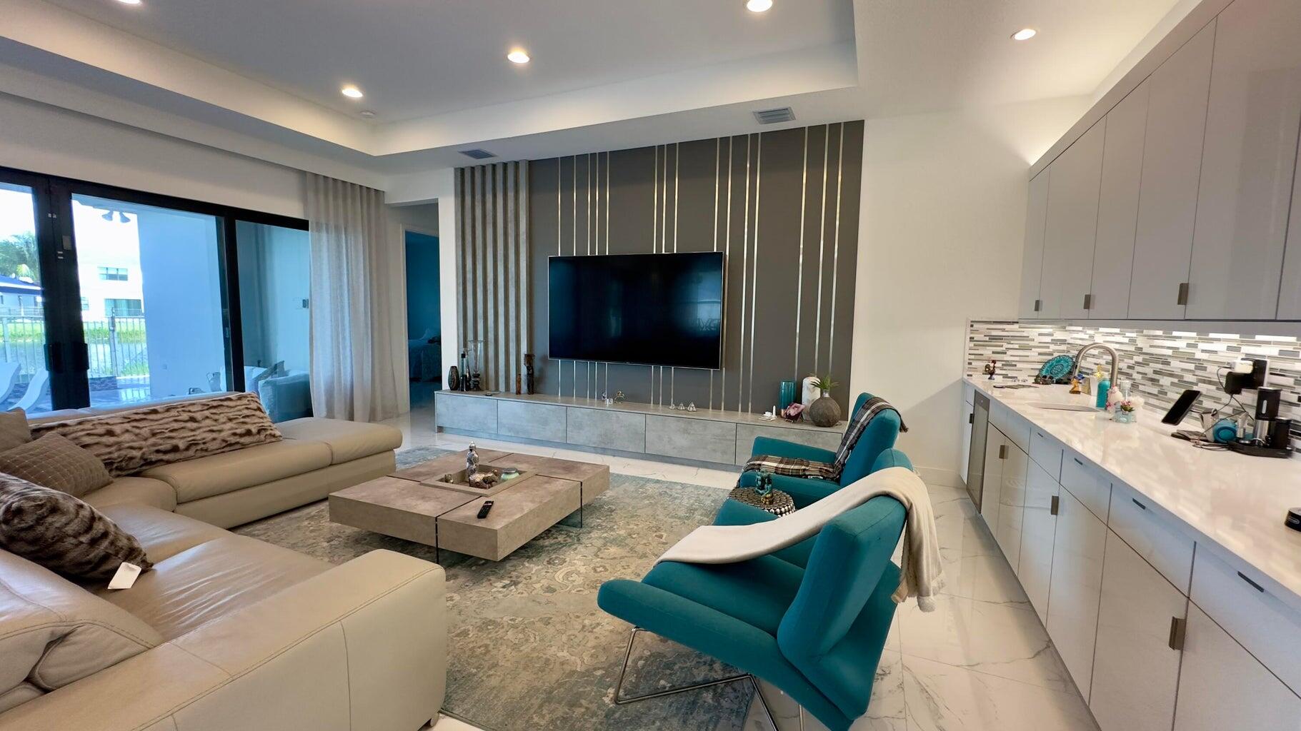 8817 New River Falls Road Boca Raton, FL 33496 - Photo 16 of 54 a living room with furniture and a flat screen tv