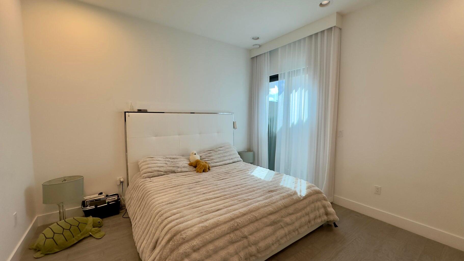 8817 New River Falls Road Boca Raton, FL 33496 - Photo 21 of 54 a bedroom with a bed and a window