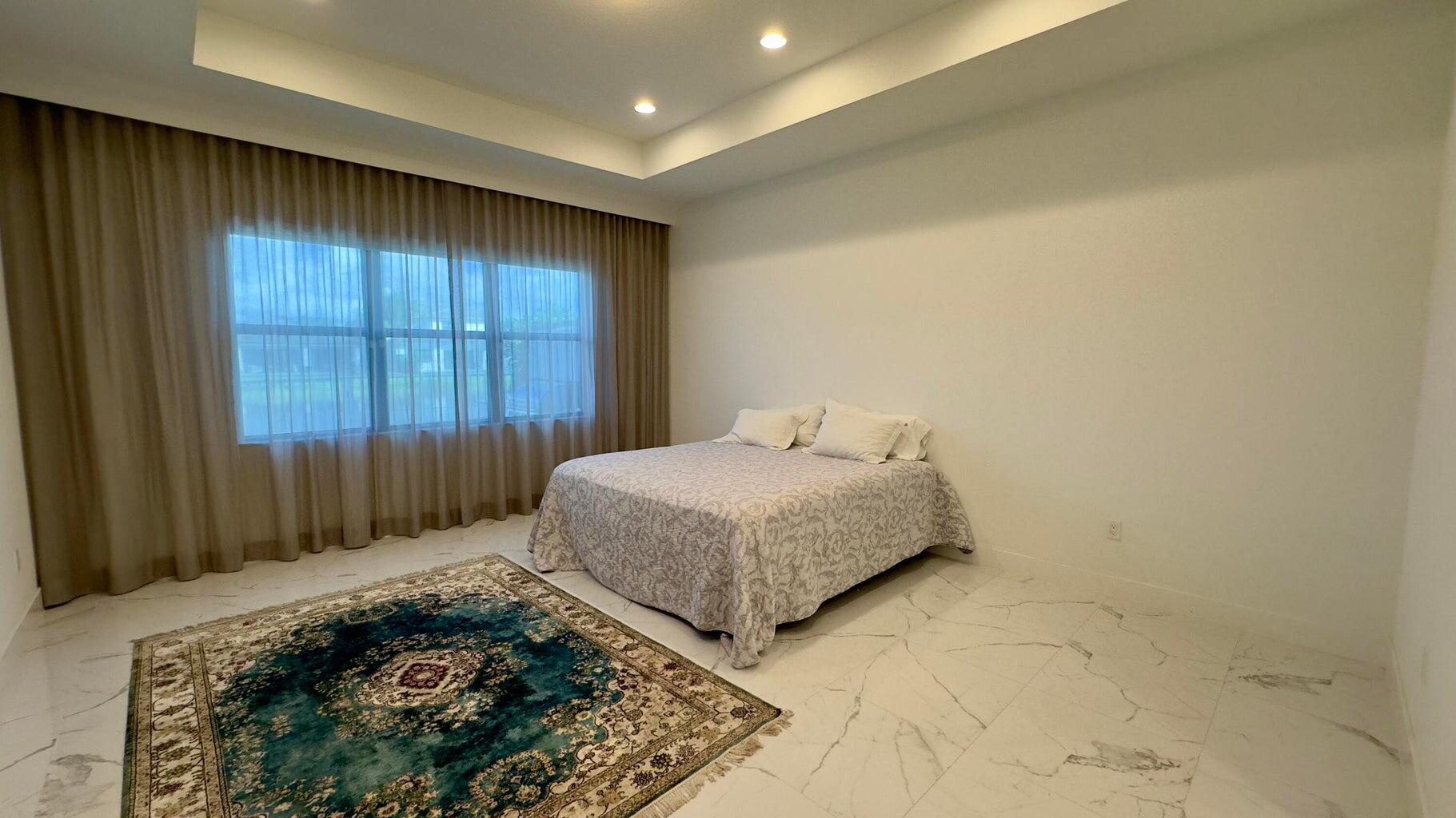 8817 New River Falls Road Boca Raton, FL 33496 - Photo 24 of 54 a bedroom with a bed and a window