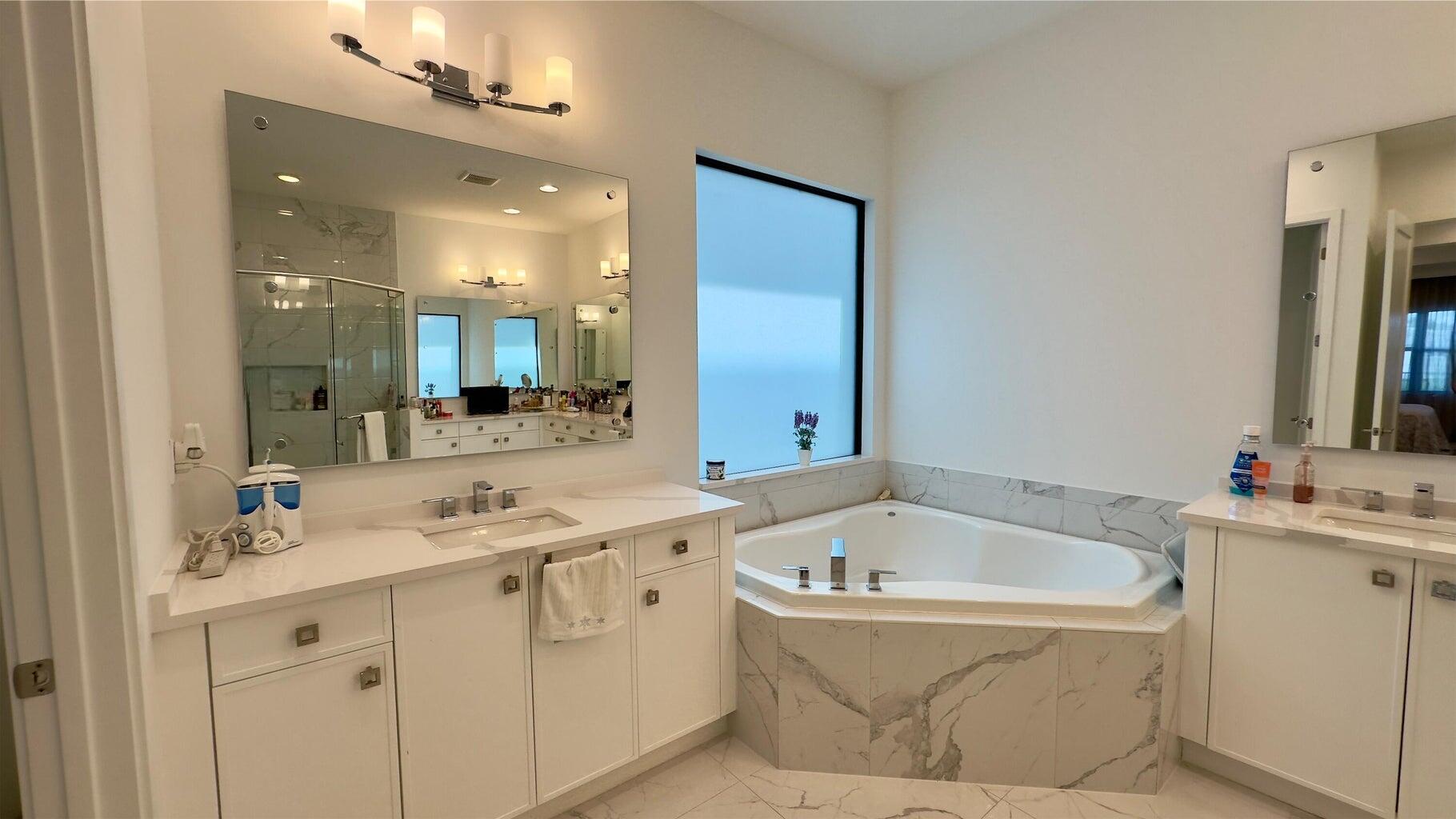 8817 New River Falls Road Boca Raton, FL 33496 - Photo 28 of 54 a bathroom with a tub sink and mirror