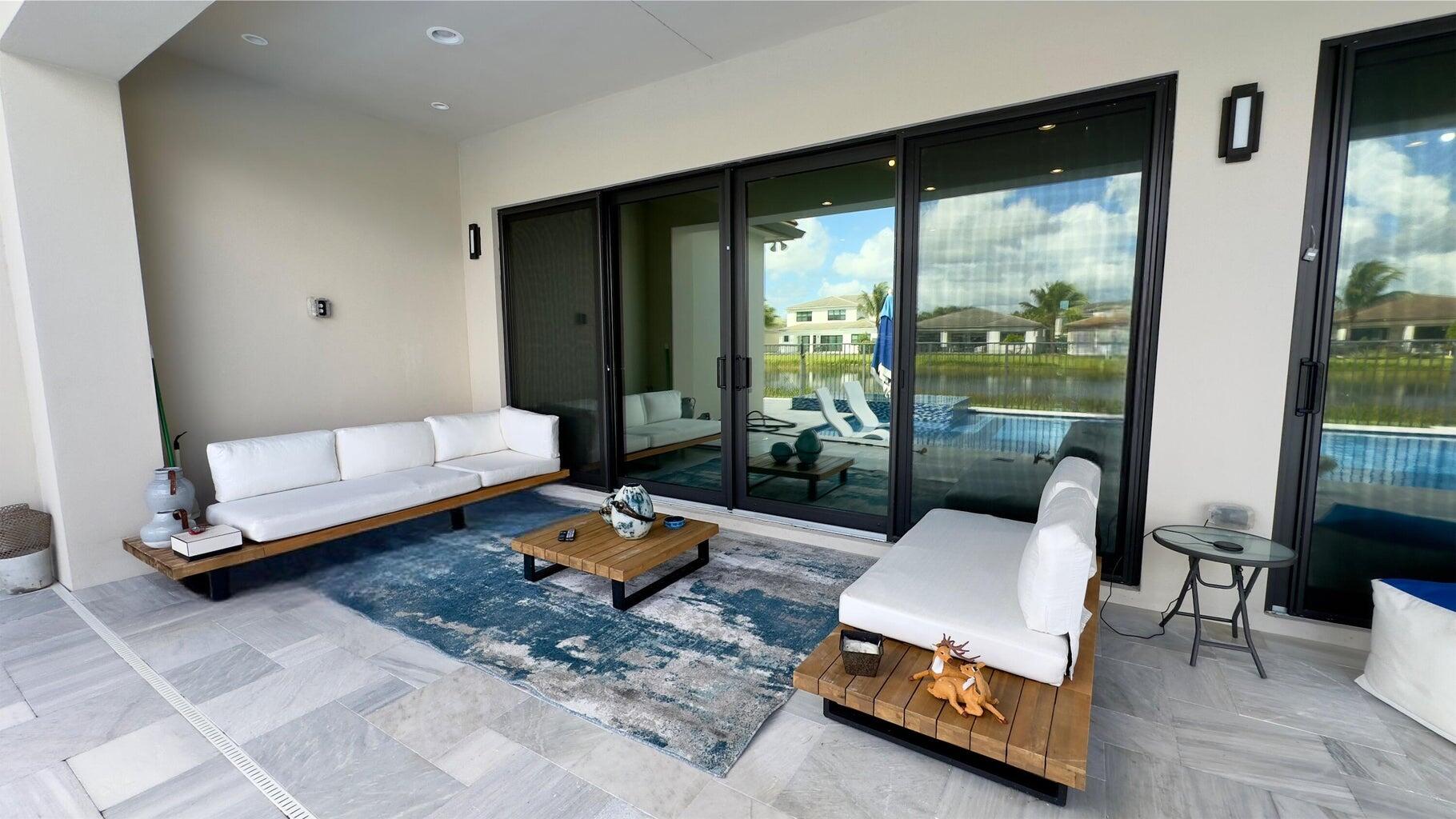 8817 New River Falls Road Boca Raton, FL 33496 - Photo 29 of 54 a living room with furniture and a floor to ceiling window