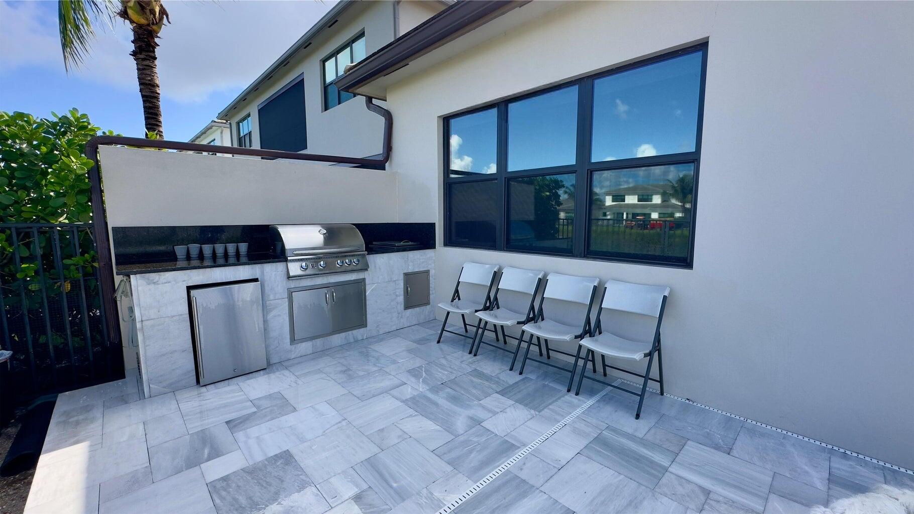 8817 New River Falls Road Boca Raton, FL 33496 - Photo 38 of 54 a kitchen with a sink and a stove top oven