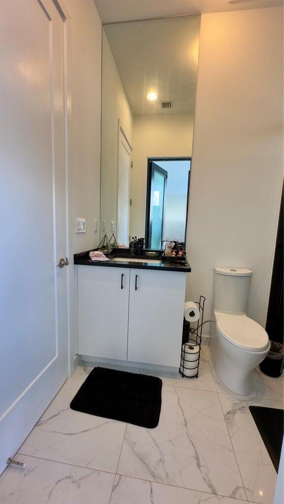 8817 New River Falls Road Boca Raton, FL 33496 - Photo 41 of 54 a bathroom with a sink a toilet and mirror