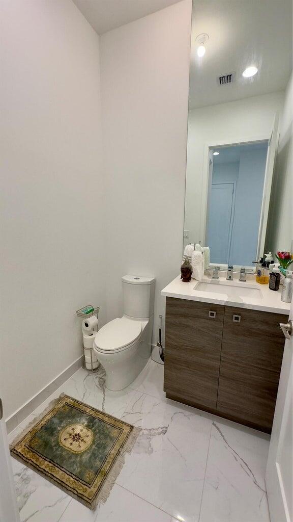 8817 New River Falls Road Boca Raton, FL 33496 - Photo 44 of 54 a bathroom with a sink a toilet and mirror