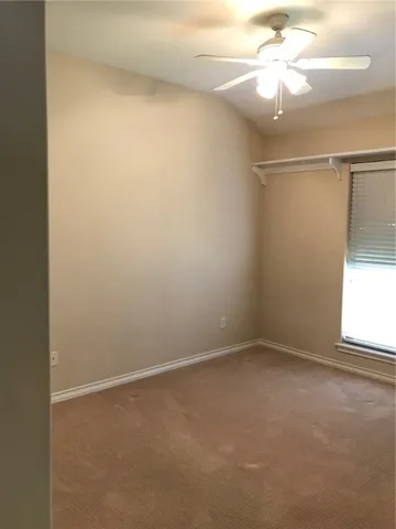 a bathroom with a granite countertop sink a toilet and mirror