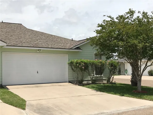 a kitchen with white cabinets and refrigerator
