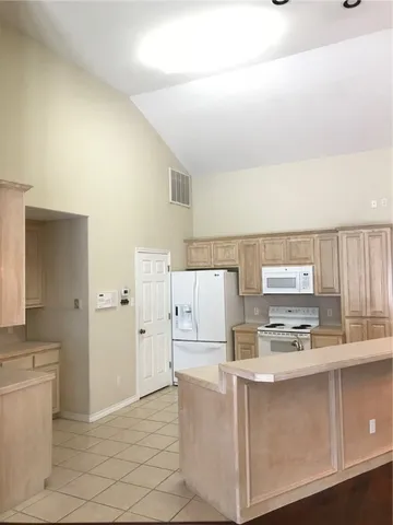 a utility room with cabinets washer and dryer