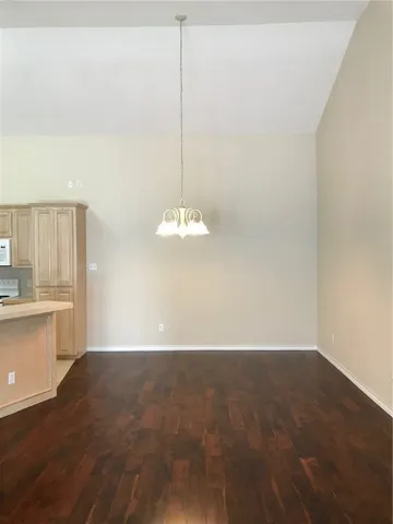 a view of a kitchen with wooden floor and electronic appliances