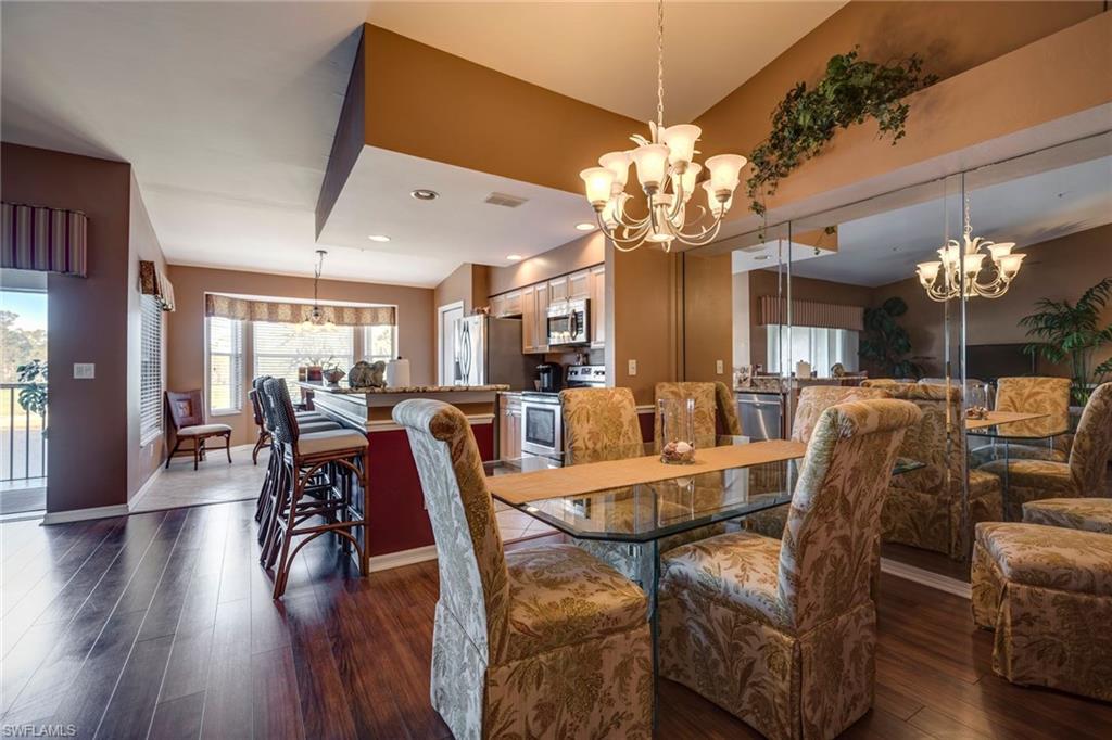 7635 Arbor Lake Court, Unit 2423 Naples, FL 34112 - Photo 12 of 35 a view of a dining room with furniture and wooden floor