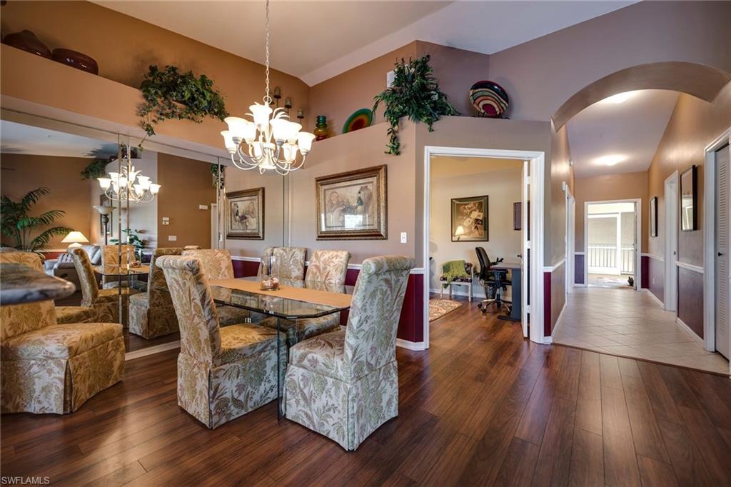 7635 Arbor Lake Court, Unit 2423 Naples, FL 34112 - Photo 13 of 35 a view of a dining room with furniture wooden floor and chandelier