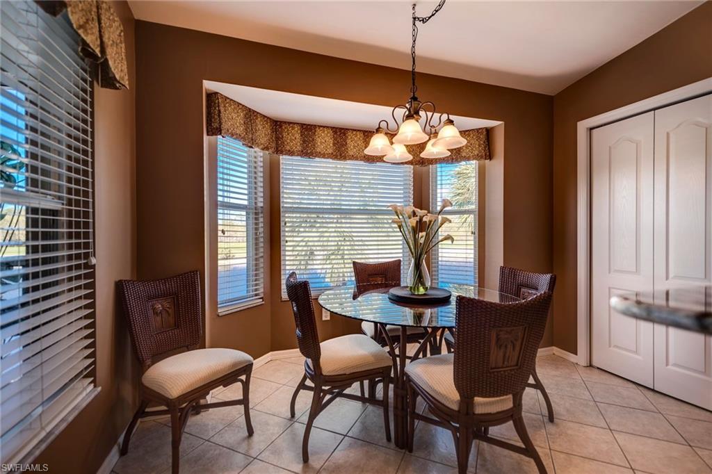 7635 Arbor Lake Court, Unit 2423 Naples, FL 34112 - Photo 14 of 35 a view of a dining room with furniture window and wooden floor
