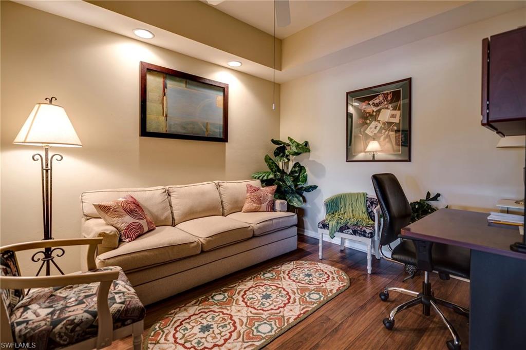7635 Arbor Lake Court, Unit 2423 Naples, FL 34112 - Photo 15 of 35 a living room with furniture a desk and chair with potted plant