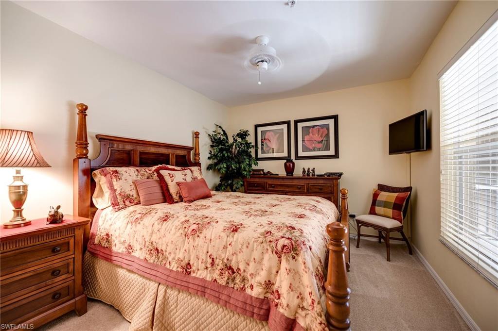 7635 Arbor Lake Court, Unit 2423 Naples, FL 34112 - Photo 18 of 35 a bedroom with bed and a flat screen tv