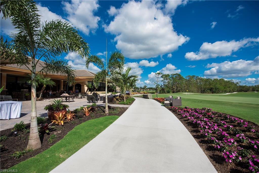 7635 Arbor Lake Court, Unit 2423 Naples, FL 34112 - Photo 25 of 35 a view of a garden with sitting area