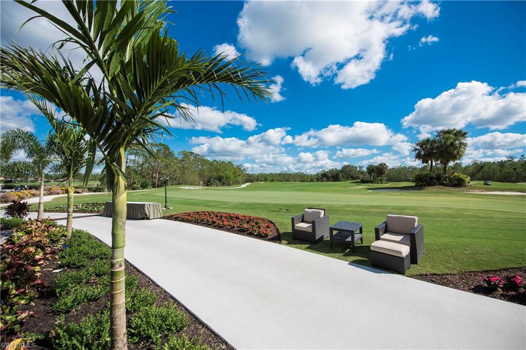 7635 Arbor Lake Court, Unit 2423 Naples, FL 34112 - Photo 26 of 35 a view of a lake with couches and wooden fence