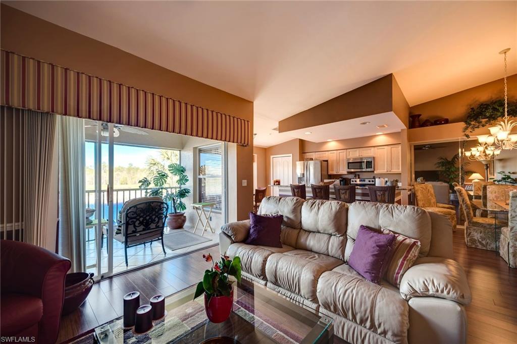 7635 Arbor Lake Court, Unit 2423 Naples, FL 34112 - Photo 7 of 35 a living room with furniture and a floor to ceiling window