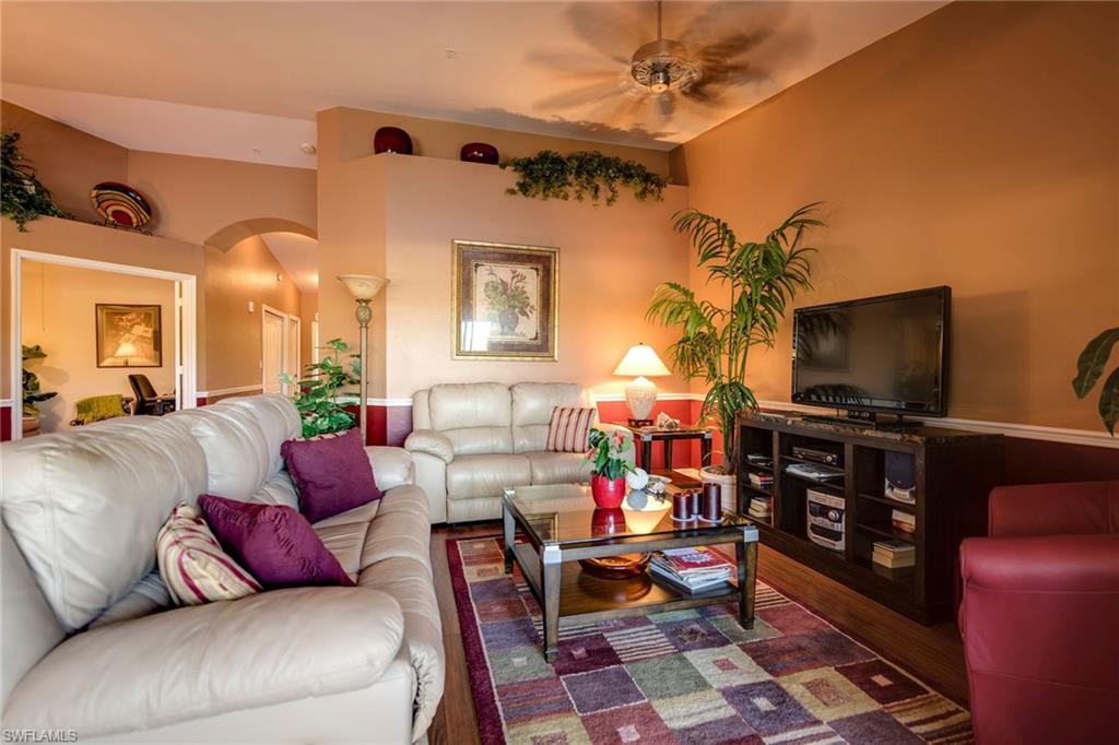 7635 Arbor Lake Court, Unit 2423 Naples, FL 34112 - Photo 8 of 35 a living room with furniture and a flat screen tv