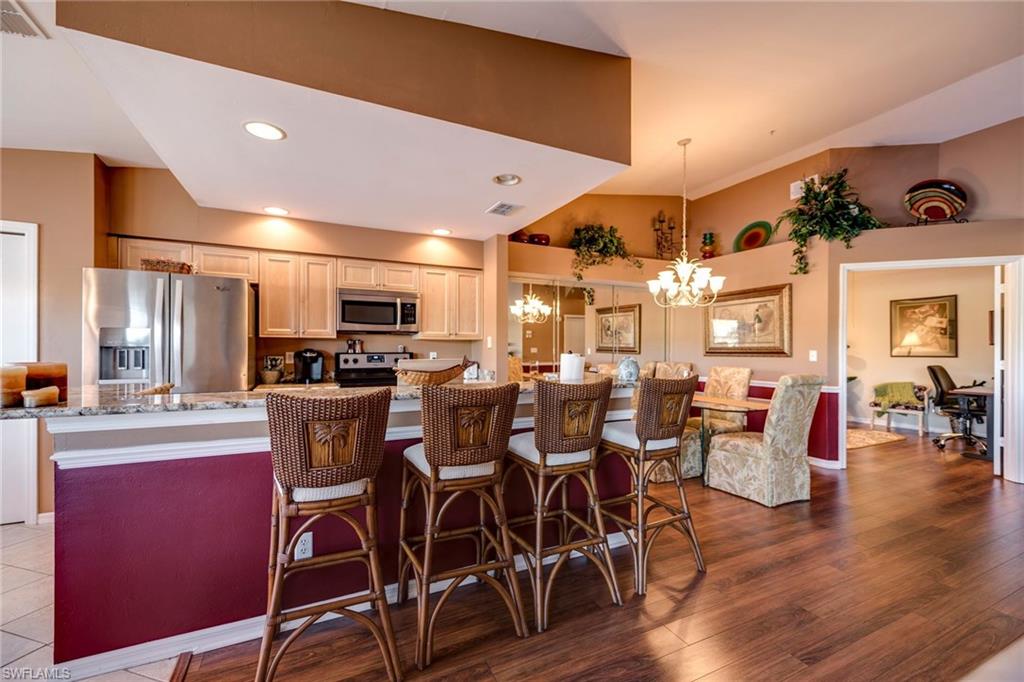 7635 Arbor Lake Court, Unit 2423 Naples, FL 34112 - Photo 10 of 35 a view of a dining room with furniture window and wooden floor