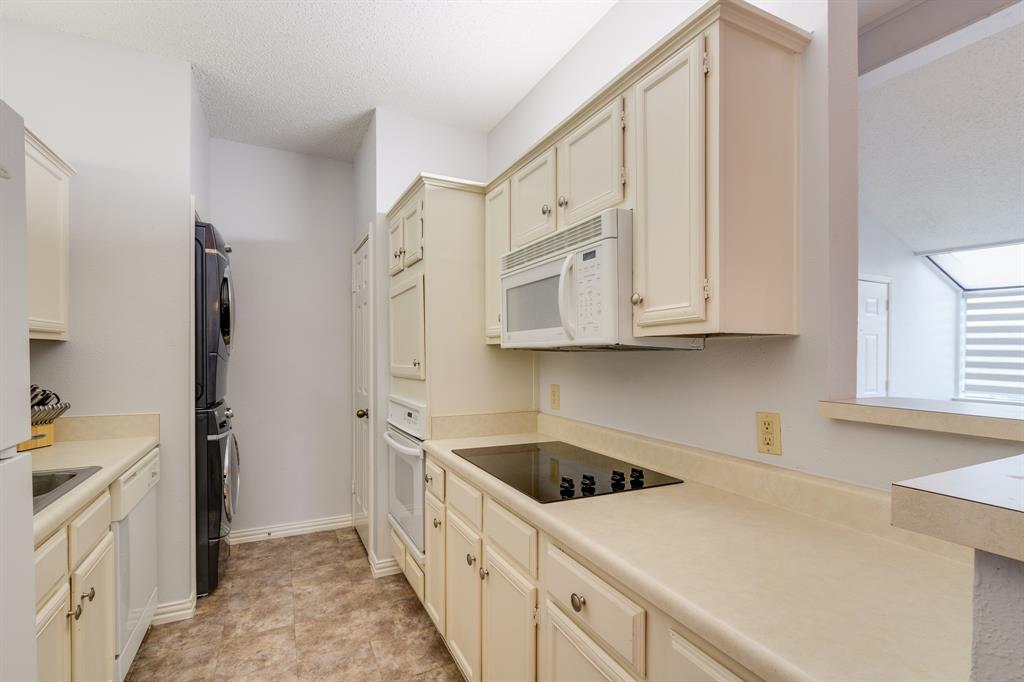 2100 Randy Snow Road, Unit 412 Arlington, TX 76011 - Photo 12 of 32 a kitchen with white cabinets and white appliances