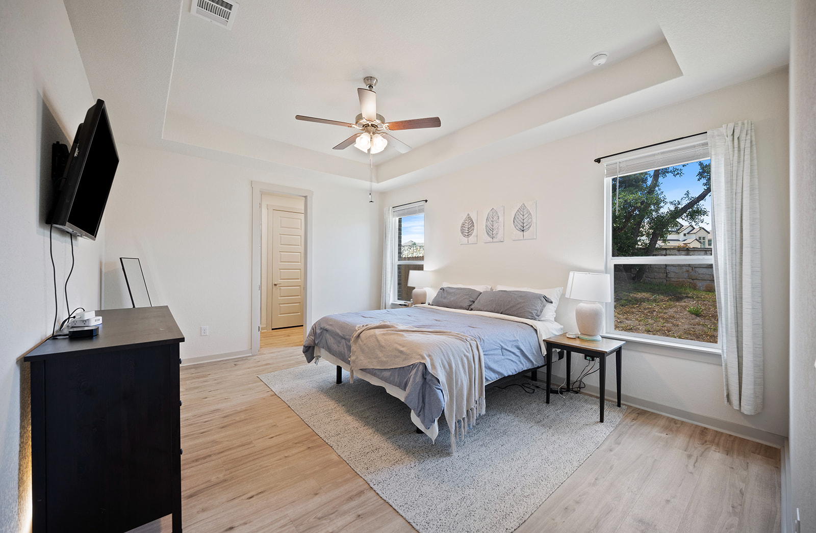 900 Balsora Cove Georgetown, TX 78628 - Photo 10 of 39 Recessed tray ceilings elevate this tranquil bedroom, offering ample space and bright window views.