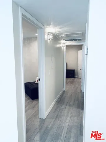 a view of a room with wooden floor