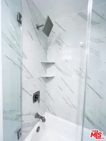 a bathroom with a bathtub and shower