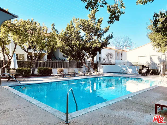 a view of a swimming pool with lounge chair